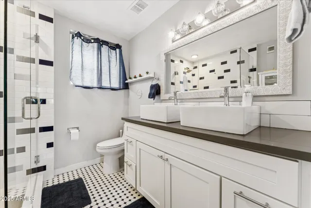 a bathroom with a sink a toilet and shower curtain