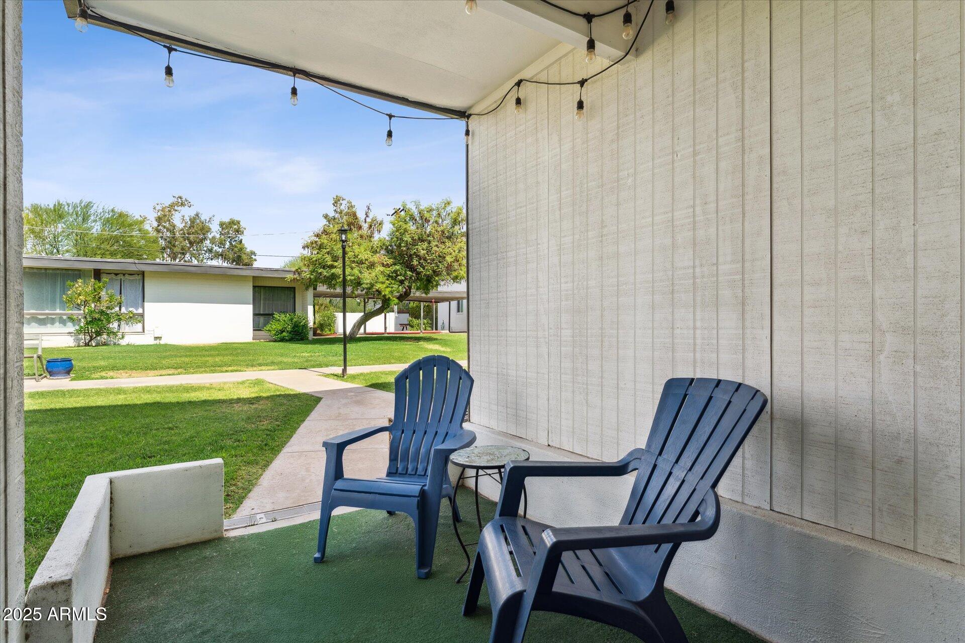 3242 East Camelback Road, Unit 105 Phoenix, AZ 85018 - Photo 21 of 24 a view of a chair and table in the garden