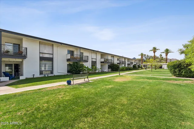 a view of a patio with a table and chairs