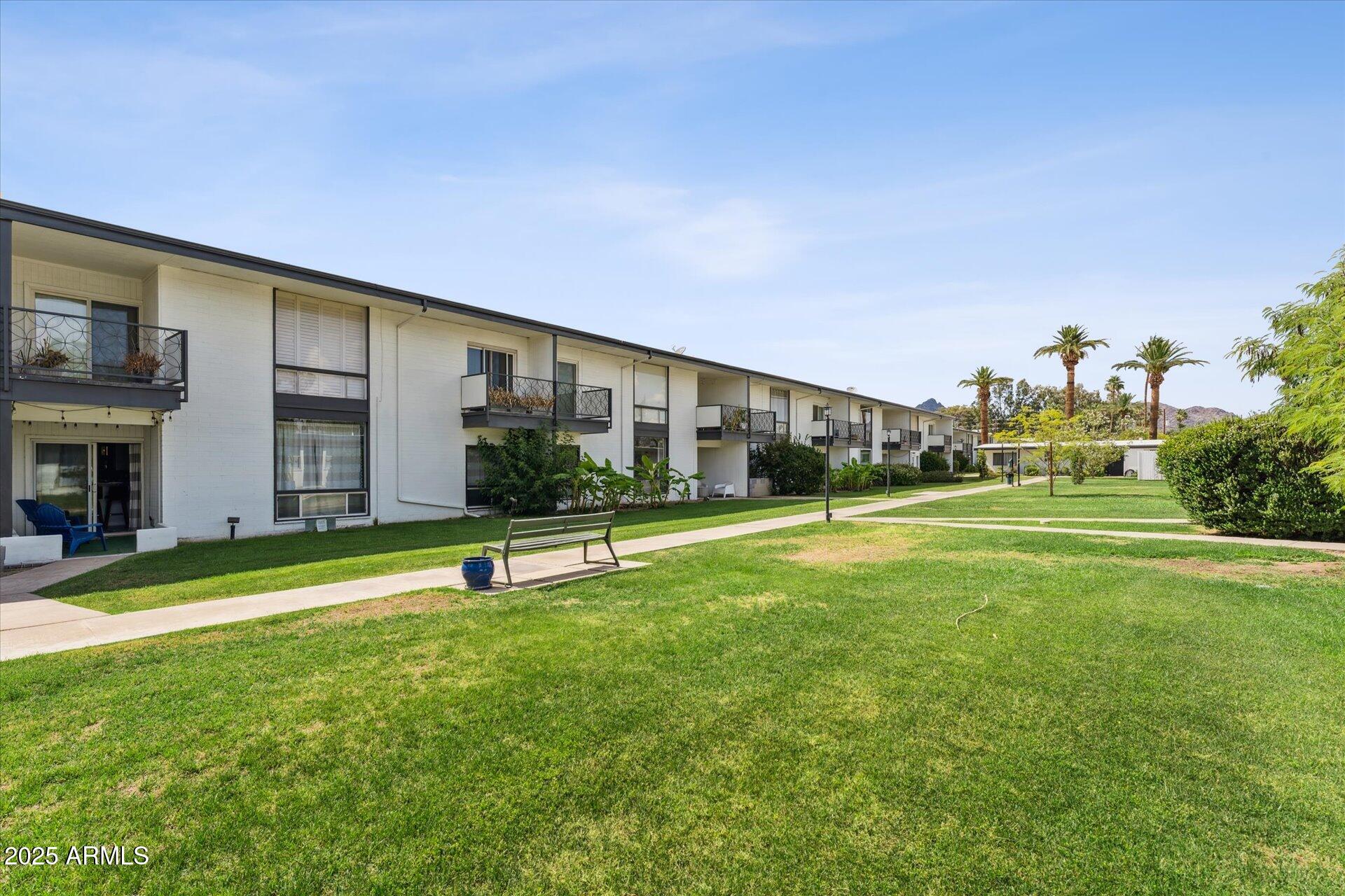 3242 East Camelback Road, Unit 105 Phoenix, AZ 85018 - Photo 22 of 24 a view of a patio with a table and chairs