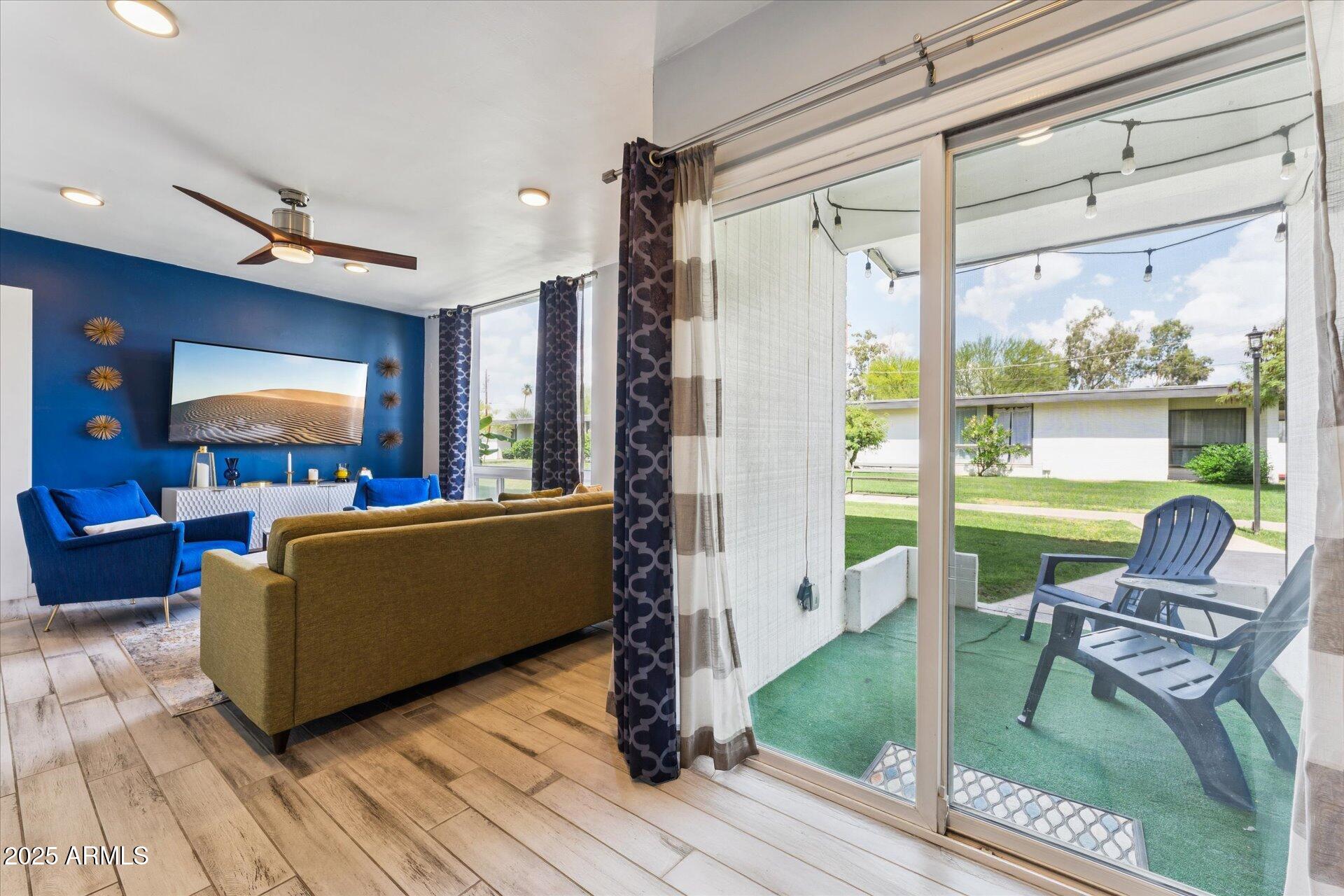 3242 East Camelback Road, Unit 105 Phoenix, AZ 85018 - Photo 4 of 24 a living room with furniture and a flat screen tv