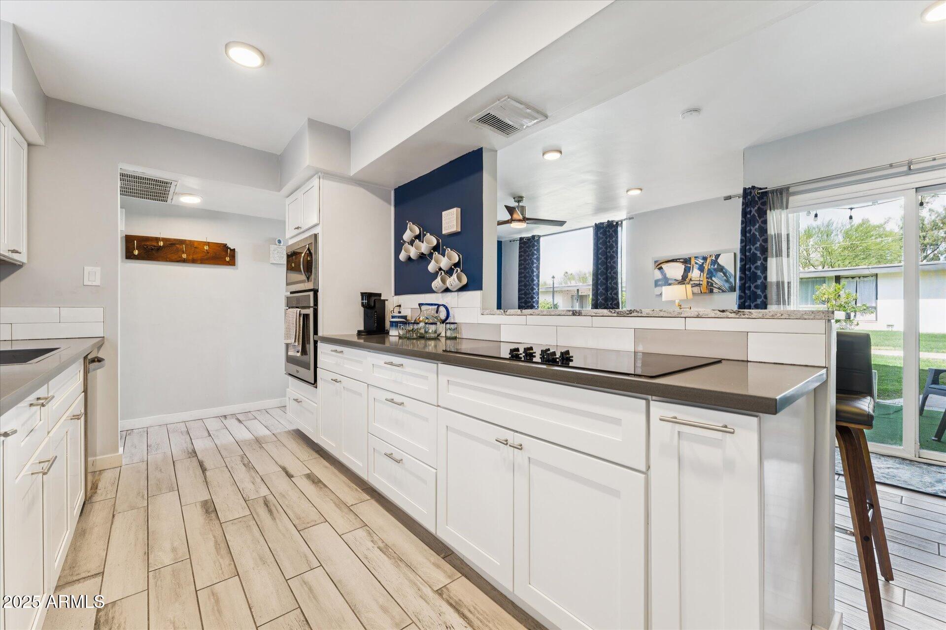 3242 East Camelback Road, Unit 105 Phoenix, AZ 85018 - Photo 6 of 24 a spacious bathroom with a granite countertop sink mirror and vanity