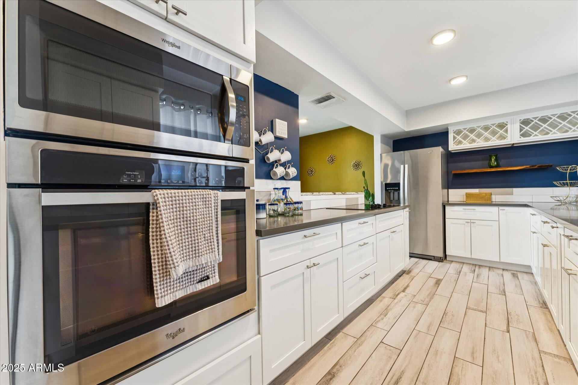 3242 East Camelback Road, Unit 105 Phoenix, AZ 85018 - Photo 7 of 24 a kitchen with stainless steel appliances granite countertop a stove and a sink