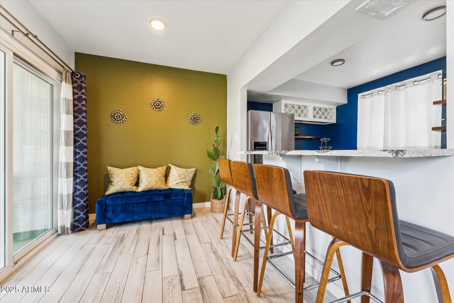 3242 East Camelback Road, Unit 105 Phoenix, AZ 85018 - Photo 10 of 24 a living room with stainless steel appliances kitchen island granite countertop furniture and a wooden floor