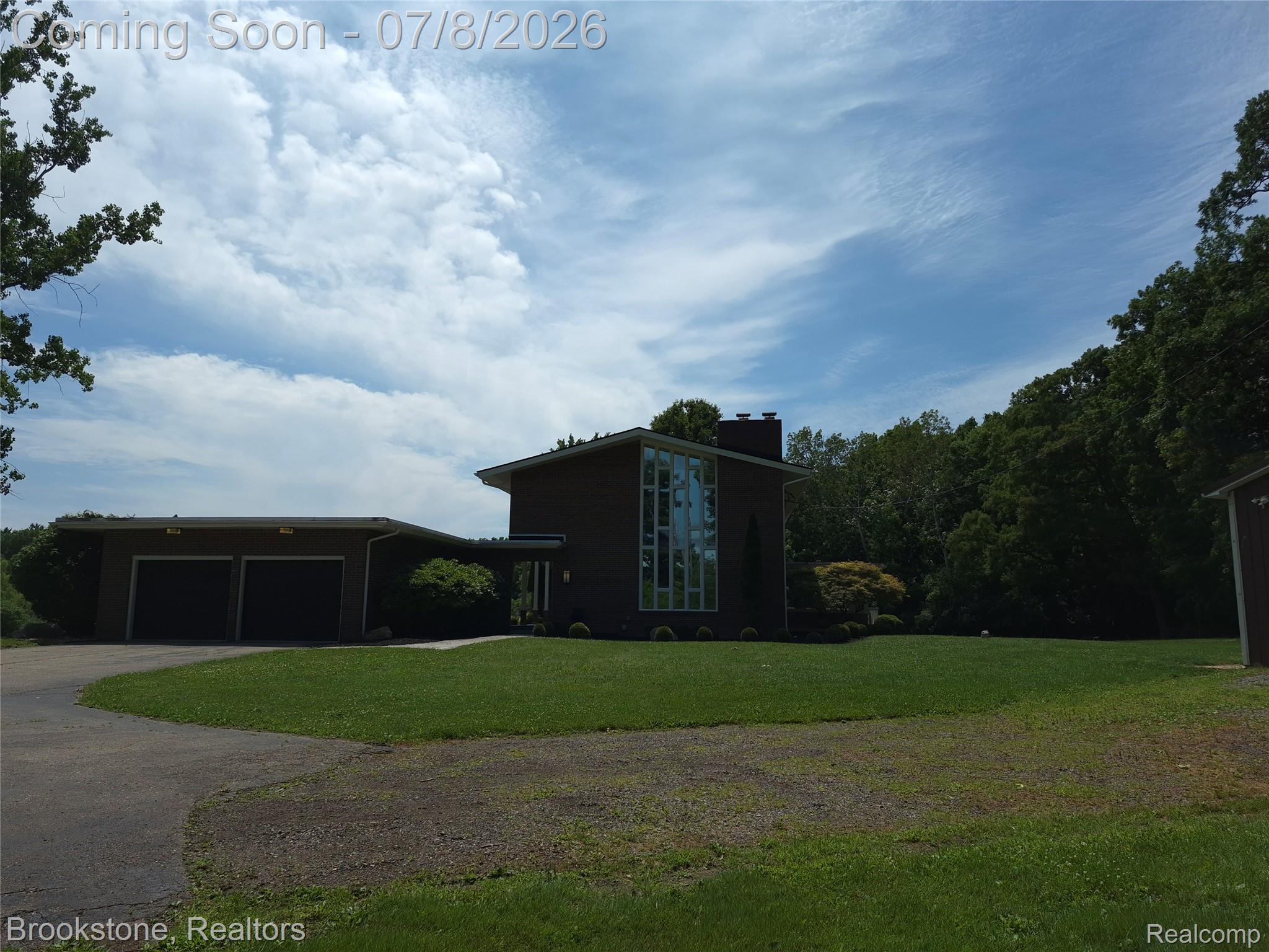 4140 South Henderson Road Davison, MI 48423 - Photo 94 of 98 Mid-century modern exterior featuring a dark facade and a prominent multi-pane window design
