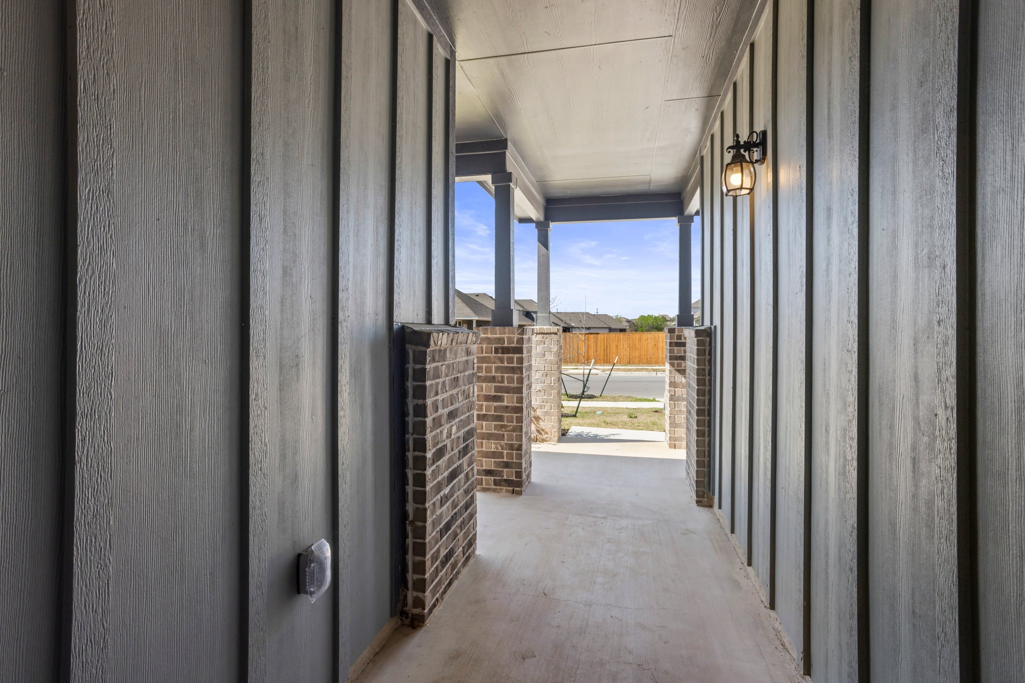 305 Brooks Ranch Drive Kyle, TX 78640 - Photo 5 of 32 a view of a hallway with wooden shelves