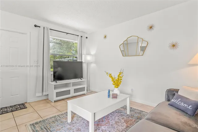 a kitchen with granite countertop a sink and a white wooden cabinets