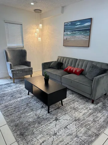 a kitchen with white cabinets and appliances