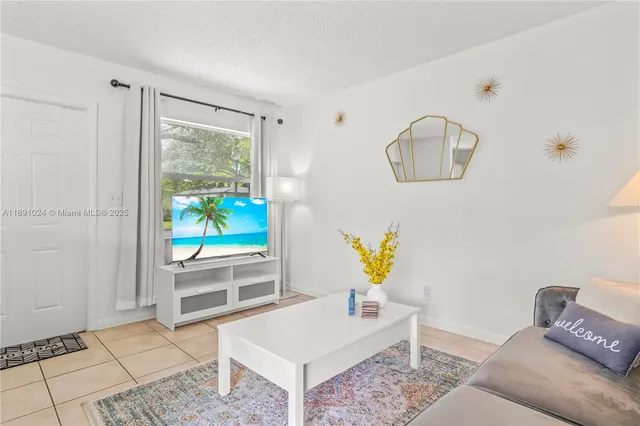a living room with furniture and a painting on the wall