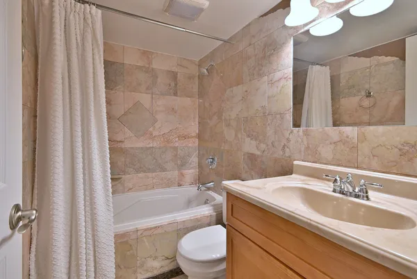a bathroom with a sink toilet a shower and a mirror