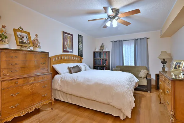 a bedroom with a large bed and a chandelier