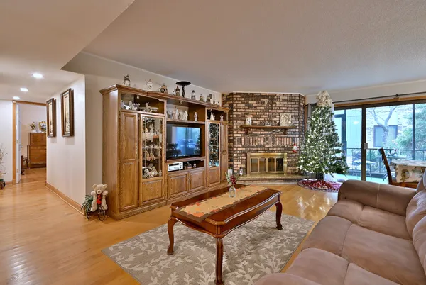 a living room with furniture a rug and a large window