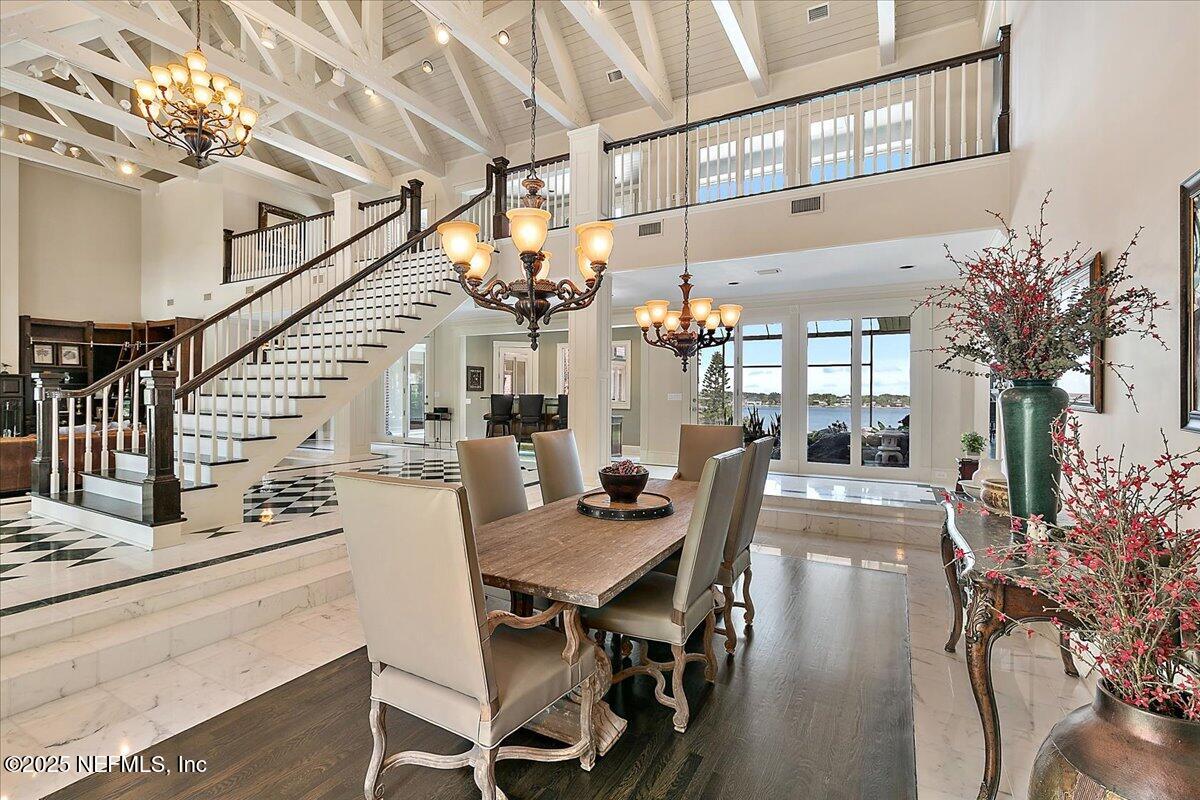 12827 Fort Caroline Road Jacksonville, FL 32225 - Photo 14 of 42 a view of a dining room with furniture and a chandelier