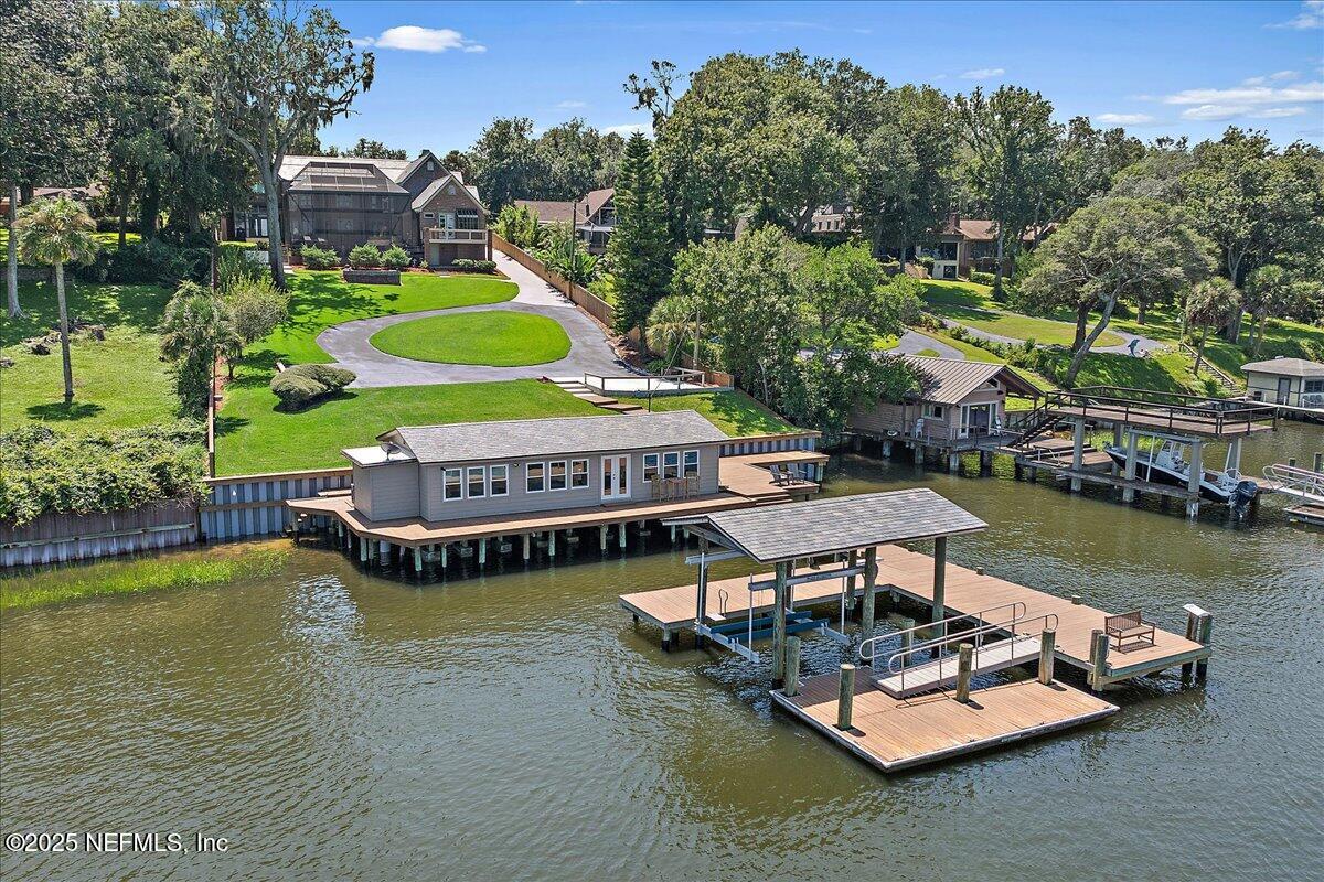 12827 Fort Caroline Road Jacksonville, FL 32225 - Photo 7 of 42 a view of a lake with couches chairs and a table of the water