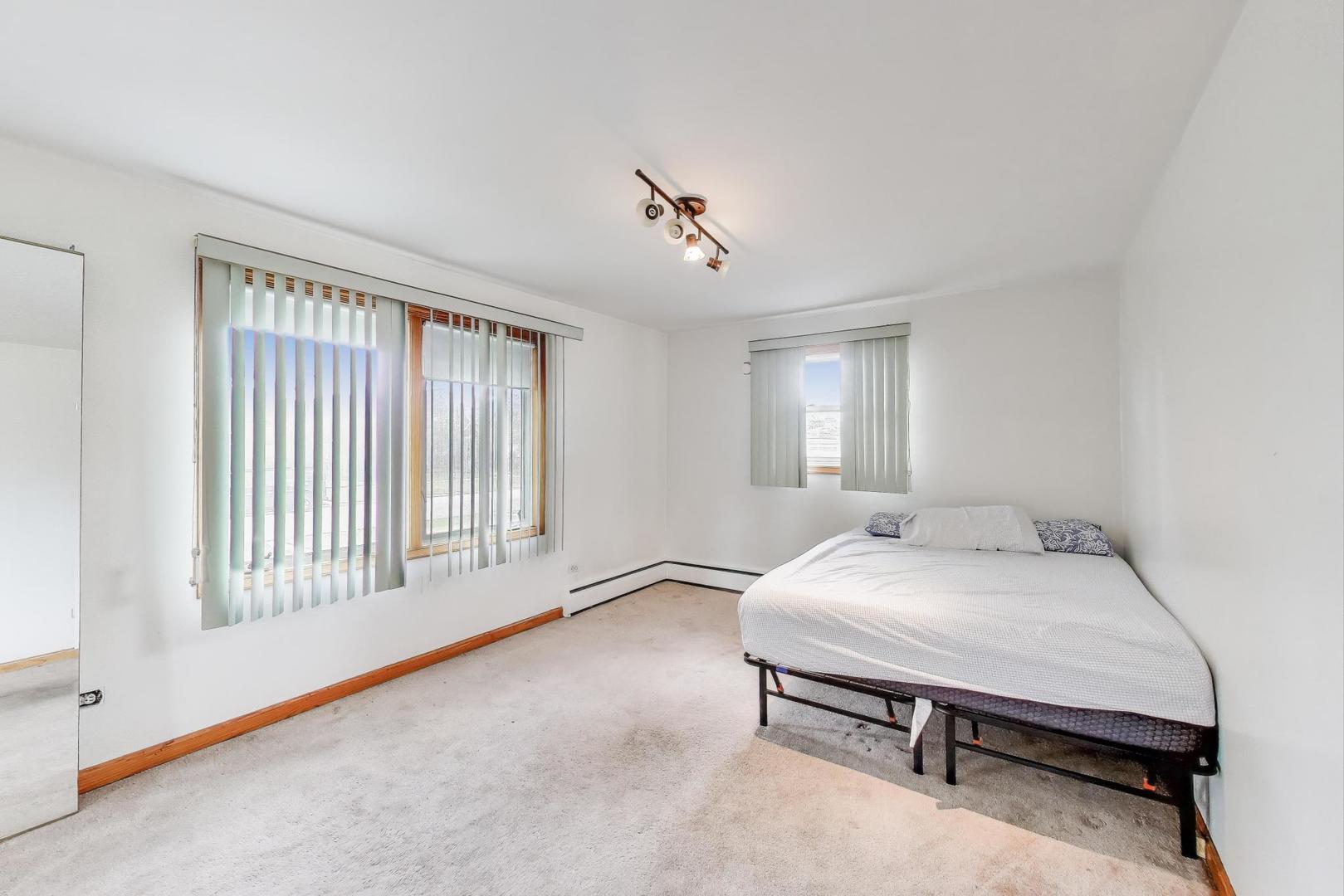 8622 South Michigan Avenue Chicago, IL 60619 - Photo 11 of 20 a bedroom with a bed and a window