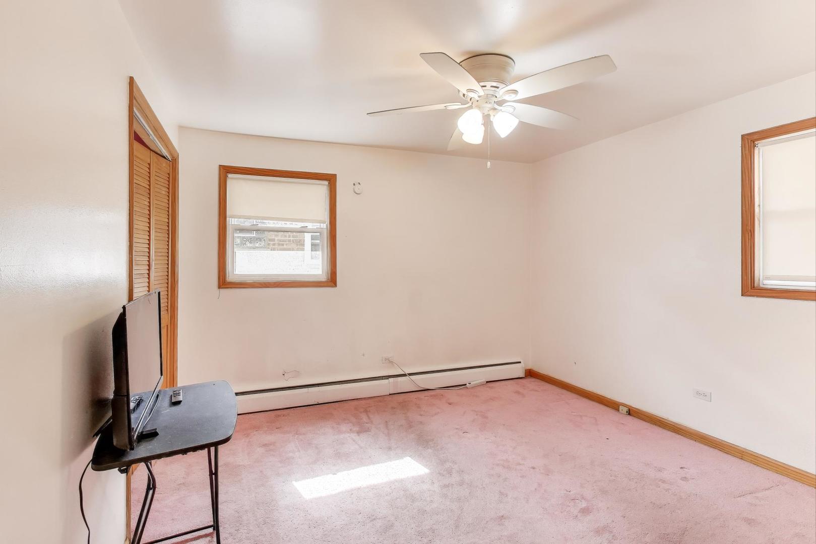 8622 South Michigan Avenue Chicago, IL 60619 - Photo 12 of 20 an empty room with windows and fan