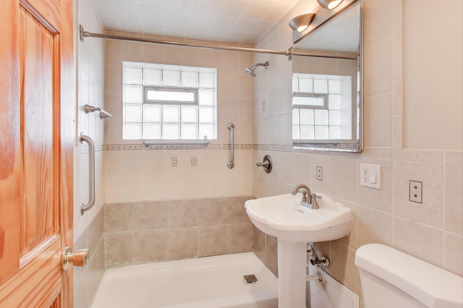 8622 South Michigan Avenue Chicago, IL 60619 - Photo 14 of 20 a bathroom with a sink bathtub and a shower
