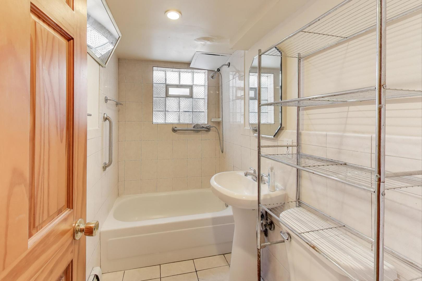8622 South Michigan Avenue Chicago, IL 60619 - Photo 17 of 20 a bathroom with a shower a bathtub and a shower