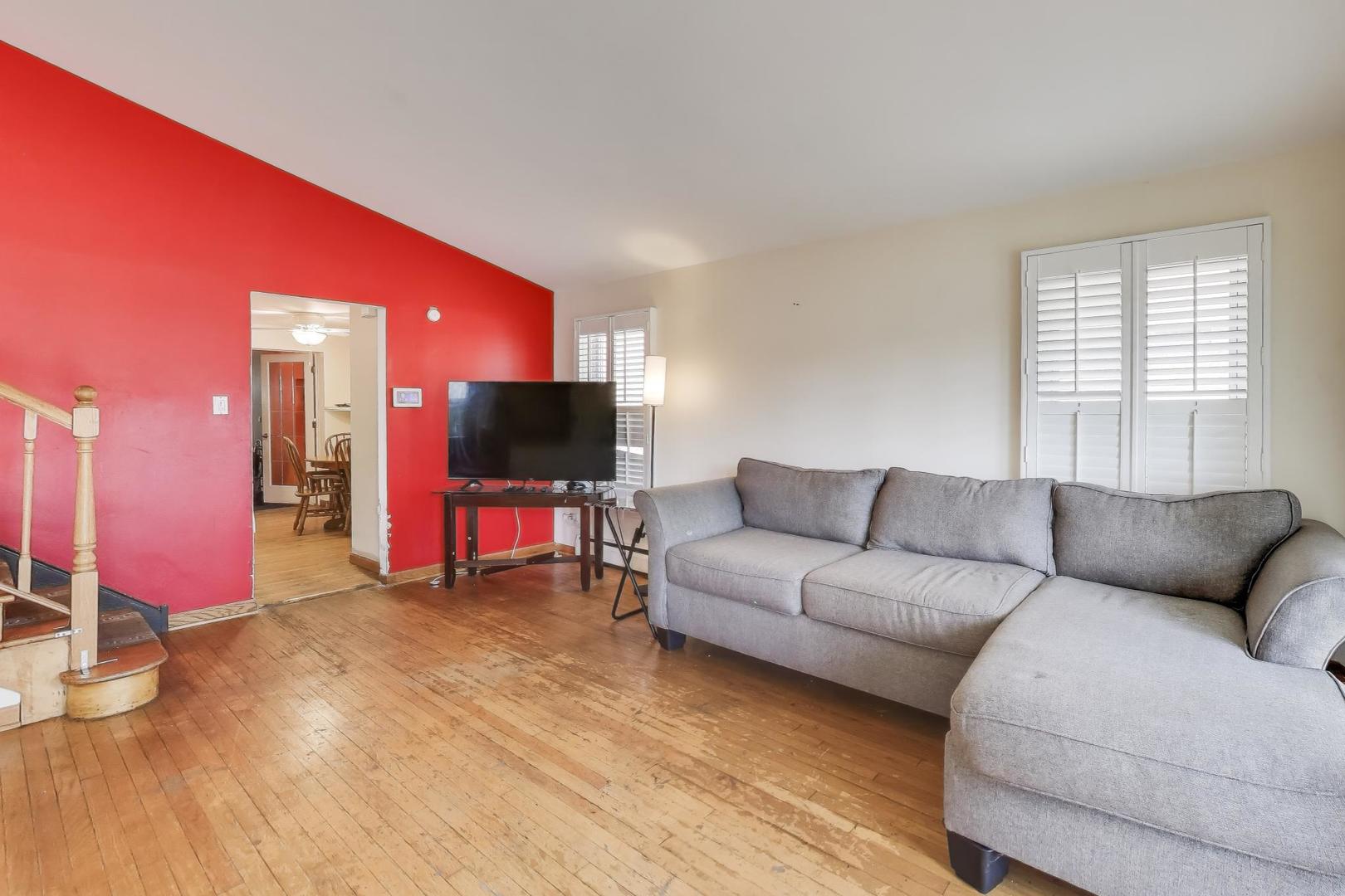 8622 South Michigan Avenue Chicago, IL 60619 - Photo 3 of 20 a living room with furniture and a flat screen tv