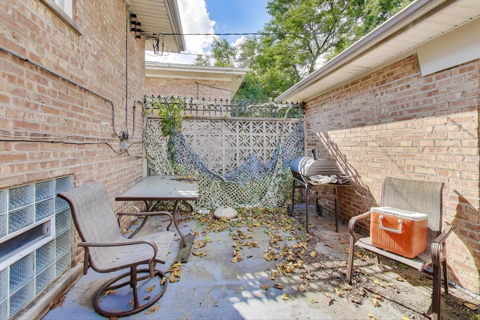 8622 South Michigan Avenue Chicago, IL 60619 - Photo 9 of 20 a view of a chairs and table in backyard