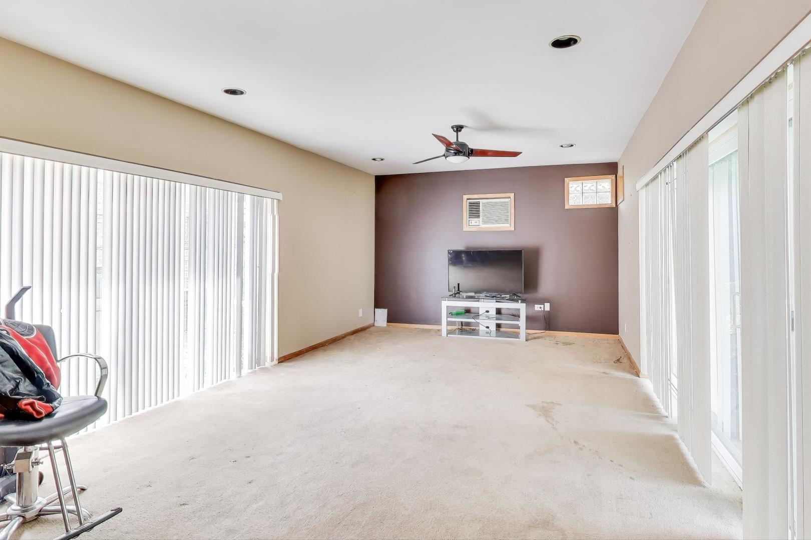 8622 South Michigan Avenue Chicago, IL 60619 - Photo 10 of 20 a view of an empty room with a fireplace and a window