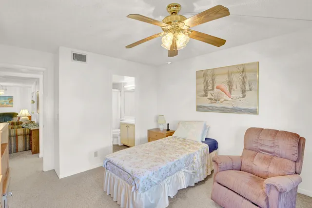 a bedroom with furniture and a chandelier