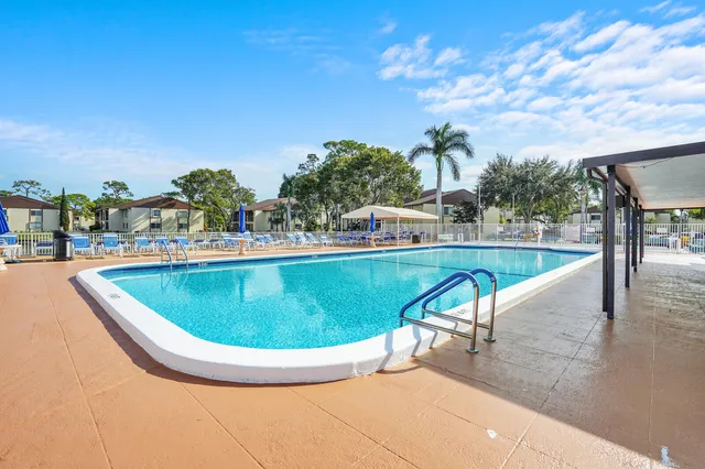 a view of a swimming pool with an outdoor seating
