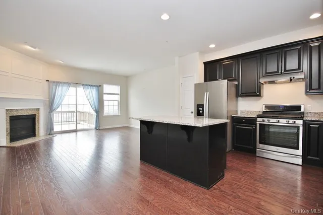 a kitchen with a sink and wooden floor
