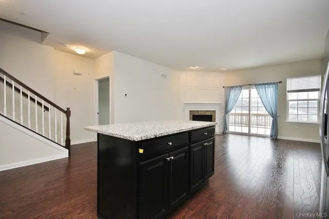 a kitchen with kitchen island a counter top space a sink appliances and cabinets