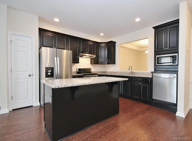a view of a kitchen with a sink and a fireplace