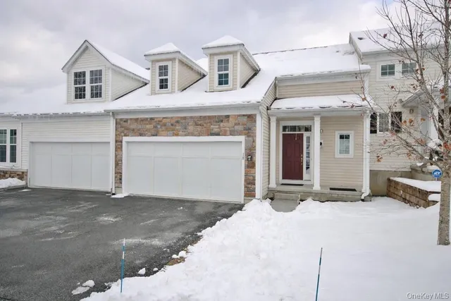 a view of a white house with large windows