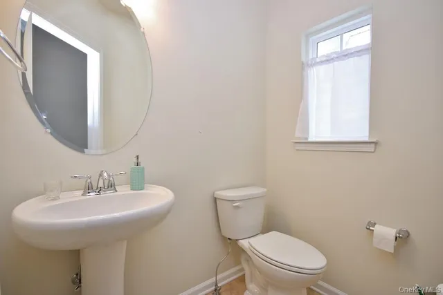 an empty room with wooden floor and mirror