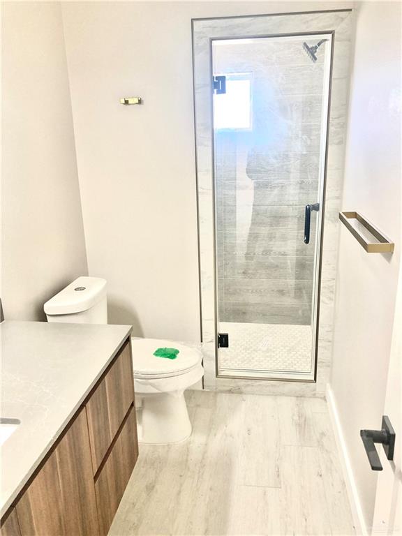 2218 Corales Street Mission, TX 78573 - Photo 17 of 22 a bathroom with a shower a toilet and a shower