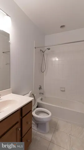 a bathroom with a granite countertop sink a toilet and shower
