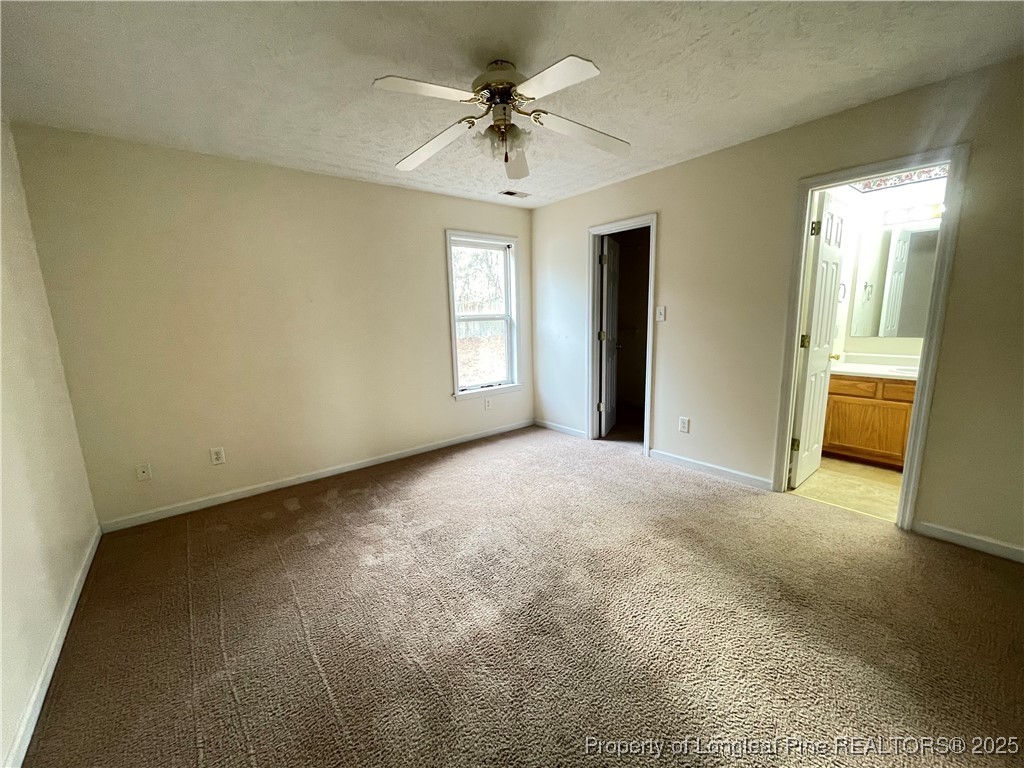 177 Deep Creek Lane Raeford, NC 28376 - Photo 18 of 28 a view of a livingroom with a chandelier fan and windows