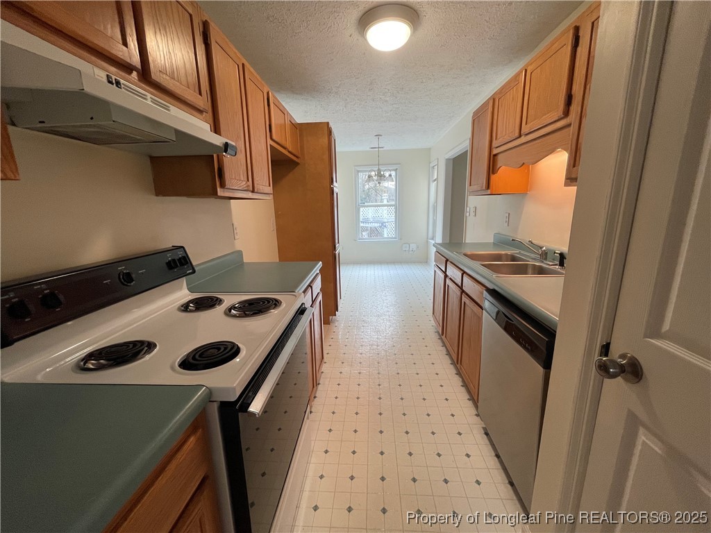 177 Deep Creek Lane Raeford, NC 28376 - Photo 25 of 28 a kitchen with granite countertop a stove and a refrigerator