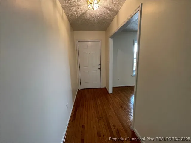 a view of a livingroom with an empty space and a fireplace