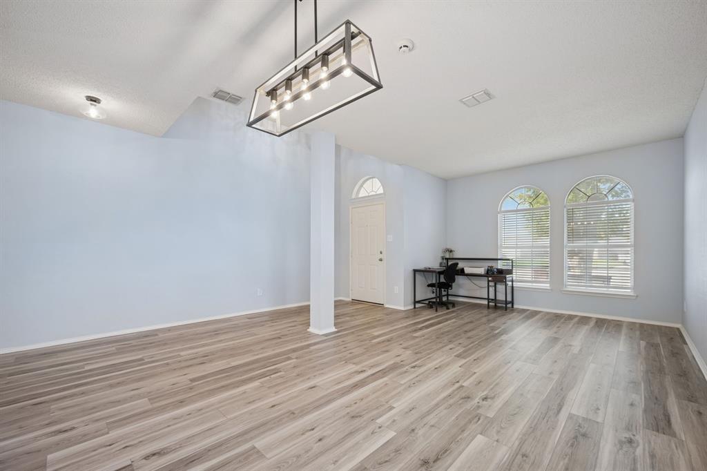 3304 Olympus Court Corinth, TX 76210 - Photo 40 of 40 an empty room with wooden floor and windows