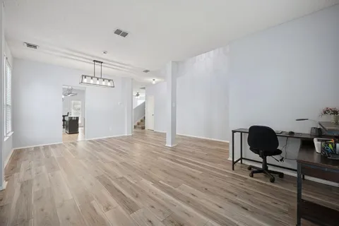 a kitchen with stainless steel appliances granite countertop a sink a stove a refrigerator cabinets and chairs