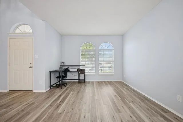 a kitchen with stainless steel appliances granite countertop a stove a sink dishwasher a refrigerator and a dining table with the chandelier