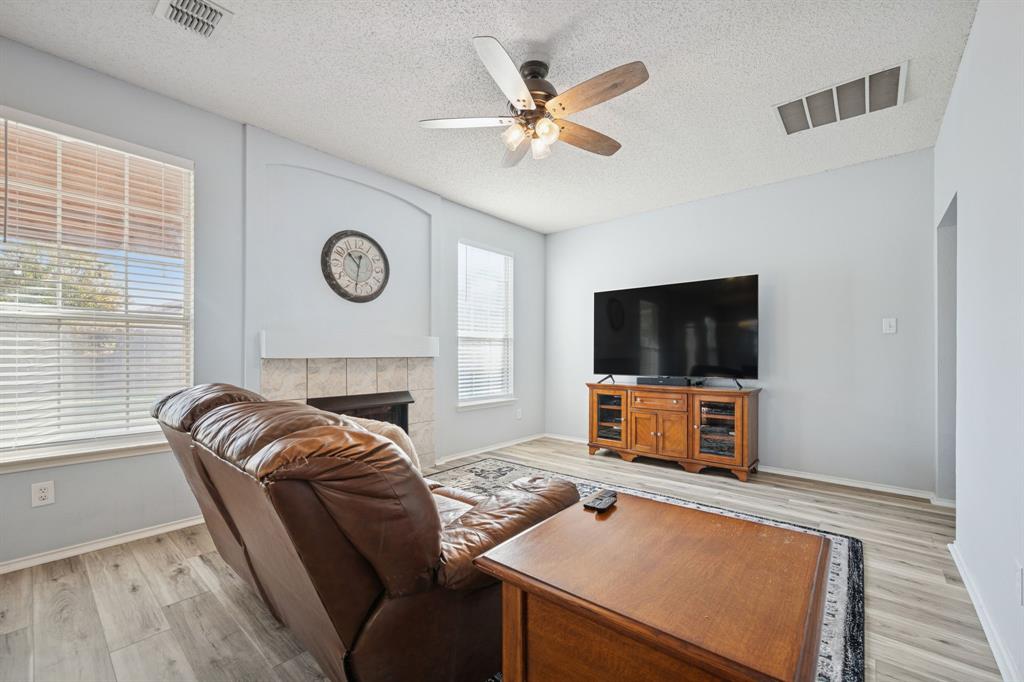 3304 Olympus Court Corinth, TX 76210 - Photo 19 of 40 a living room with furniture and a flat screen tv