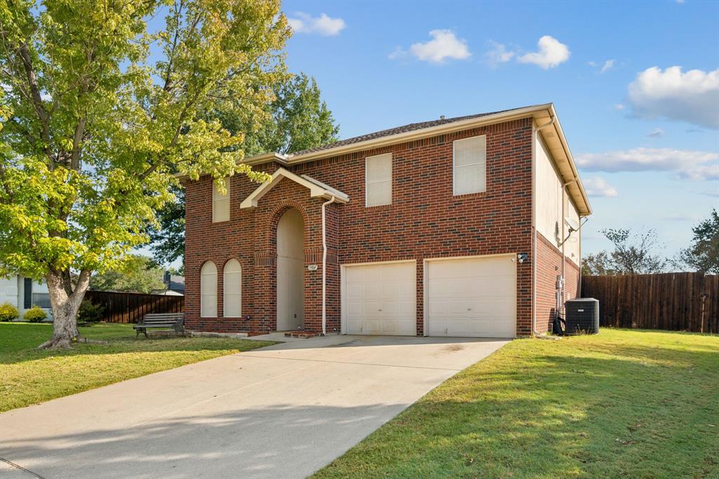 3304 Olympus Court Corinth, TX 76210 - Photo 2 of 40 a front view of a house with a yard and garage