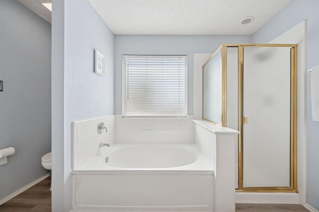 3304 Olympus Court Corinth, TX 76210 - Photo 27 of 40 a white bath tub sitting next to a window