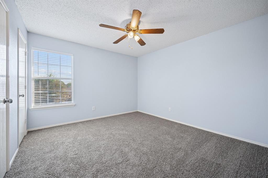 3304 Olympus Court Corinth, TX 76210 - Photo 28 of 40 an empty room with fan and windows