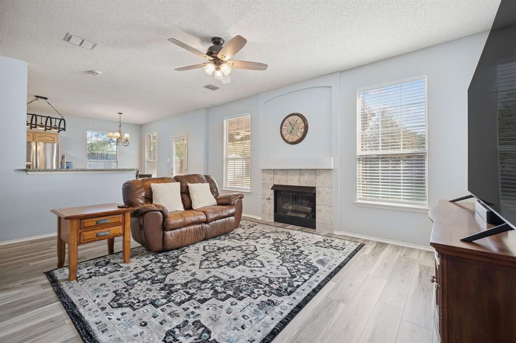 3304 Olympus Court Corinth, TX 76210 - Photo 6 of 40 a living room with furniture and a fireplace
