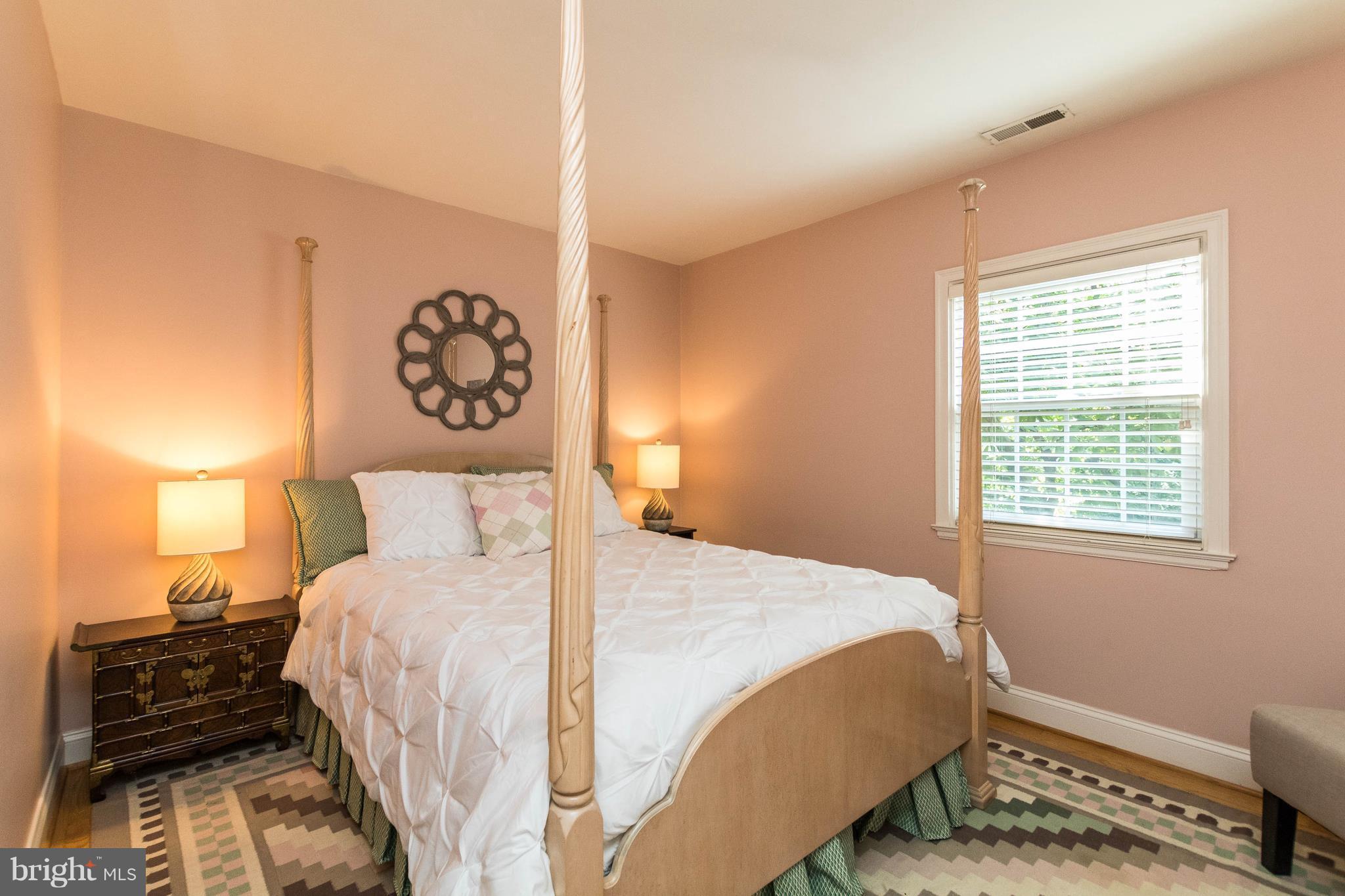 502 Worcester Road Towson, MD 21286 - Photo 19 of 30 a bedroom with a bed and a lamp
