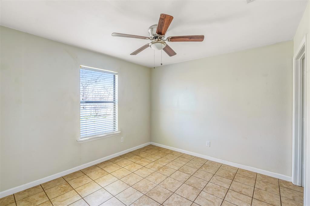 892 West Vanderbilt Street Stephenville, TX 76401 - Photo 22 of 34 an empty room with windows and fan