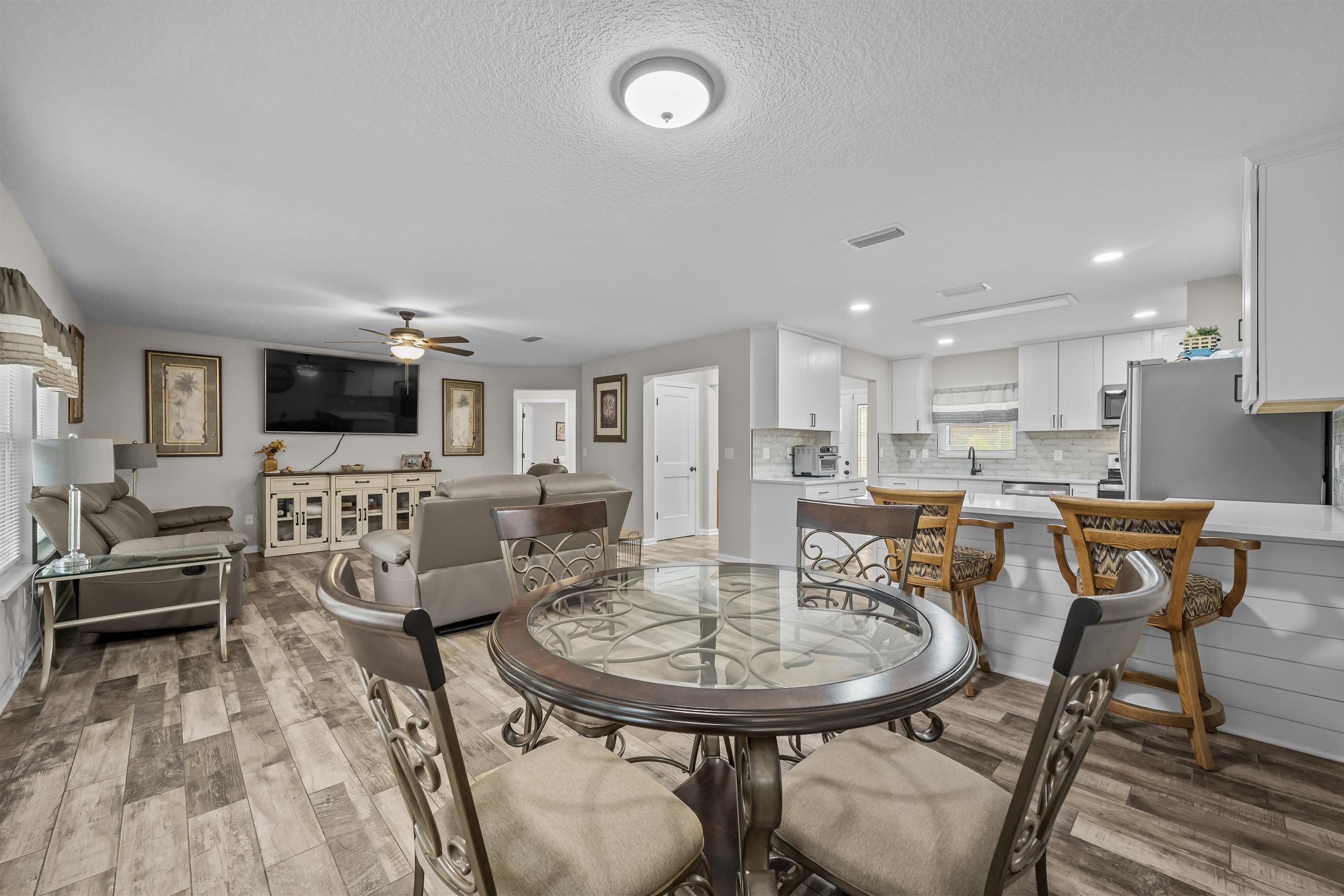 232 Kyte Road San Mateo, FL 32187 - Photo 14 of 36 Dining space featuring light wood finished floors, ceiling fan, a textured ceiling, and recessed lighting