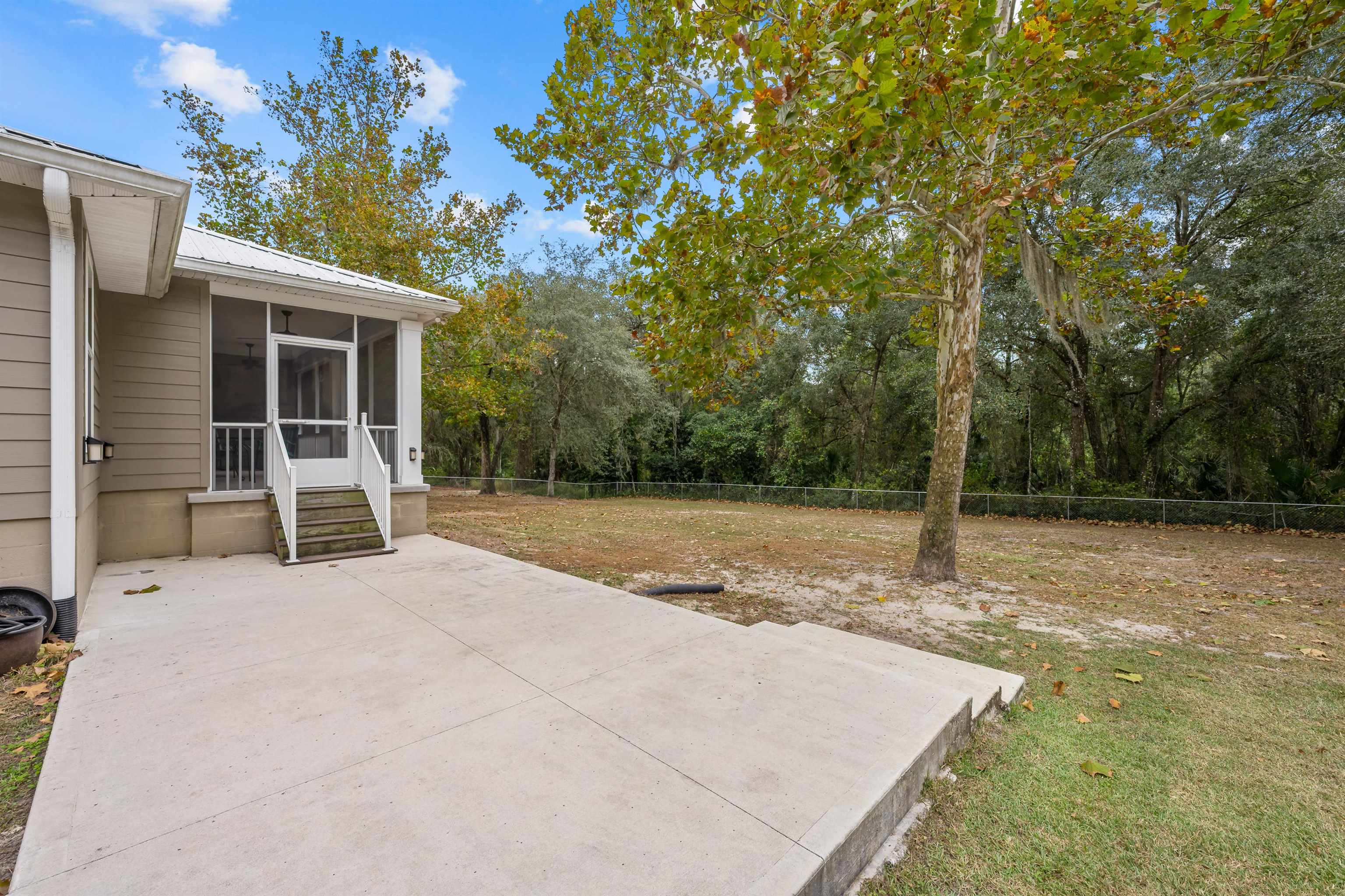 232 Kyte Road San Mateo, FL 32187 - Photo 27 of 36 Fenced backyard featuring a sunroom and a patio area