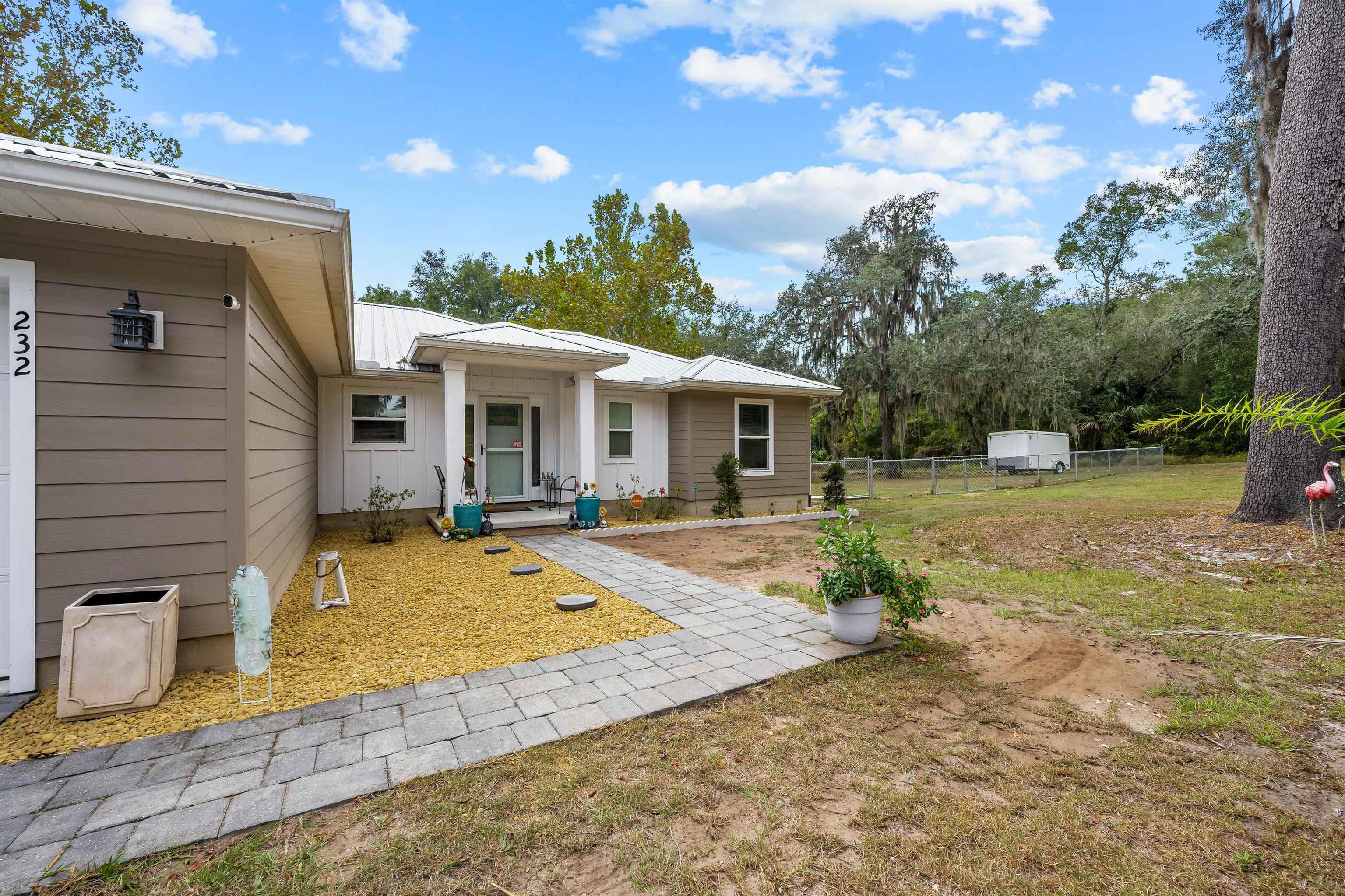 232 Kyte Road San Mateo, FL 32187 - Photo 36 of 36 Rear view of house featuring a metal roof